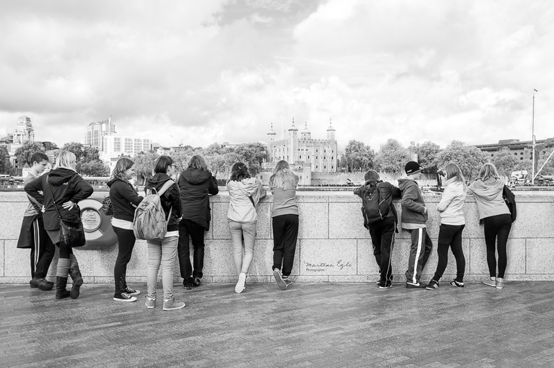 A group of teenagers looking at the Tower of London.
