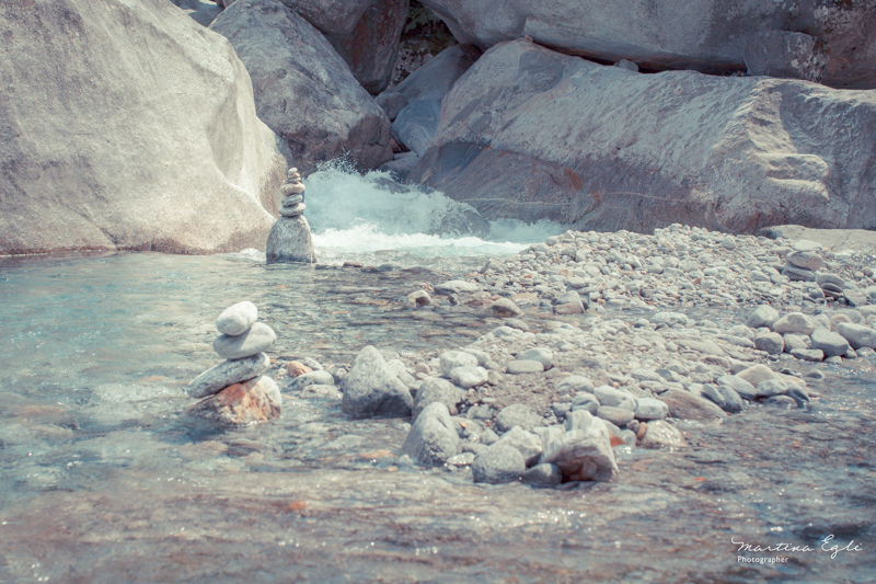 Standing-stones left in a pool at bottom of a waterfall.